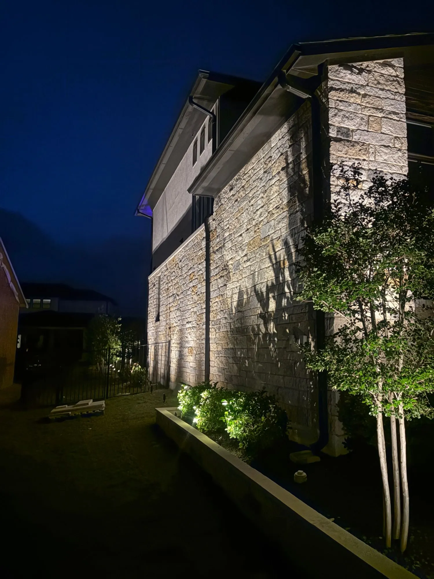 Side of a stone home lit end to end, leaving no dark corners along the perimeter